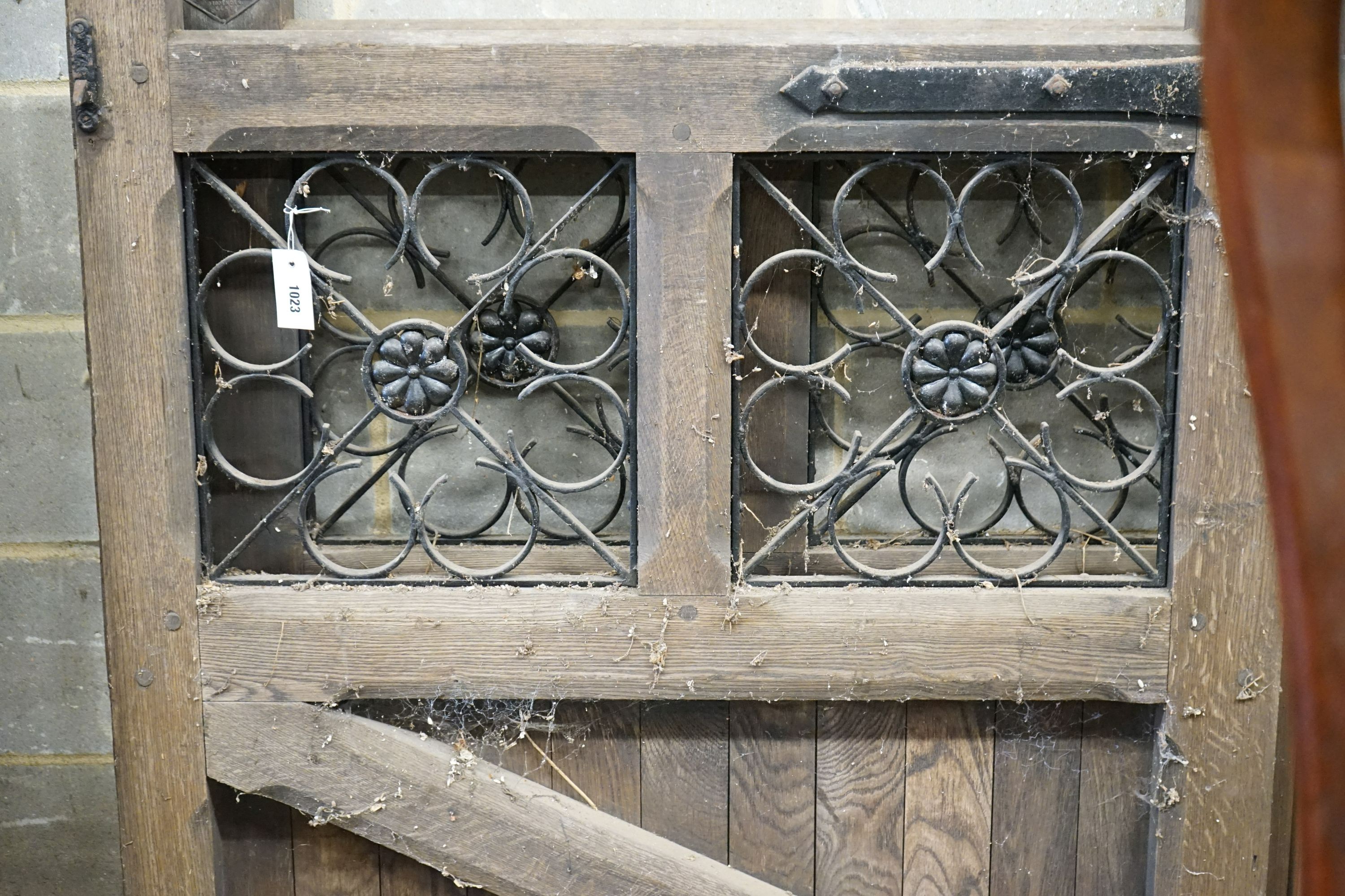A pair of oak and wrought iron gates, each width 107cm, height 133cm